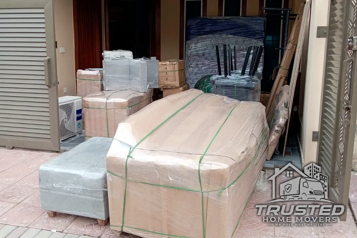 Wrapped furniture being loaded into the Trusted Home Movers truck